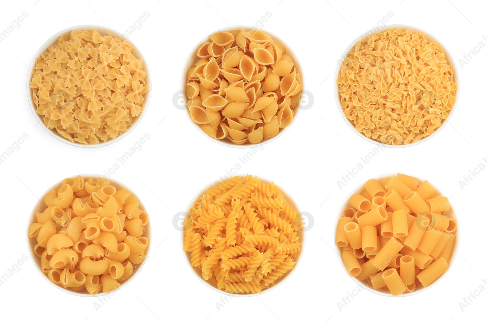 Image of Different types of pasta in bowls isolated on white, top view