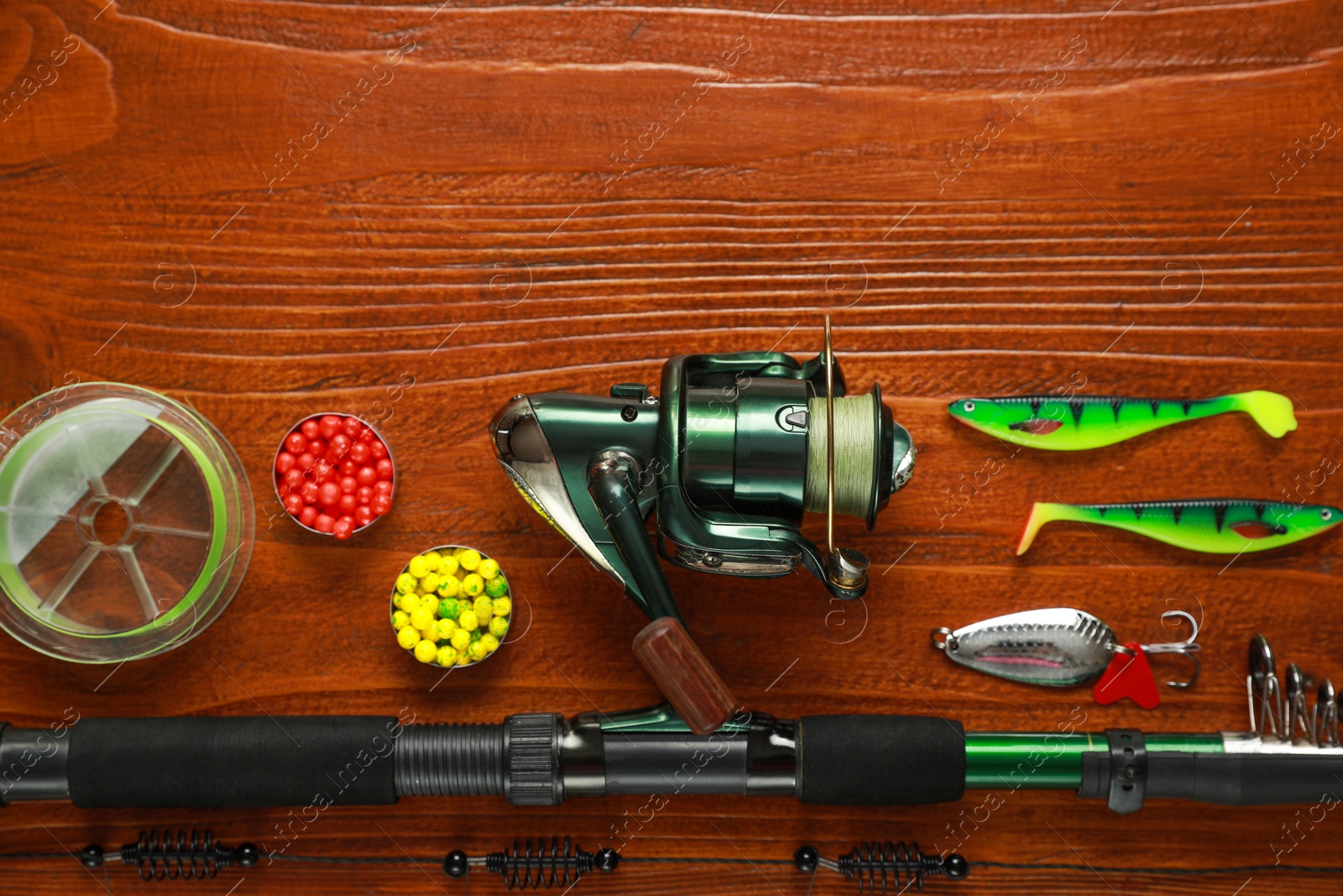 Photo of Fishing tackle on wooden table, flat lay. Space for text