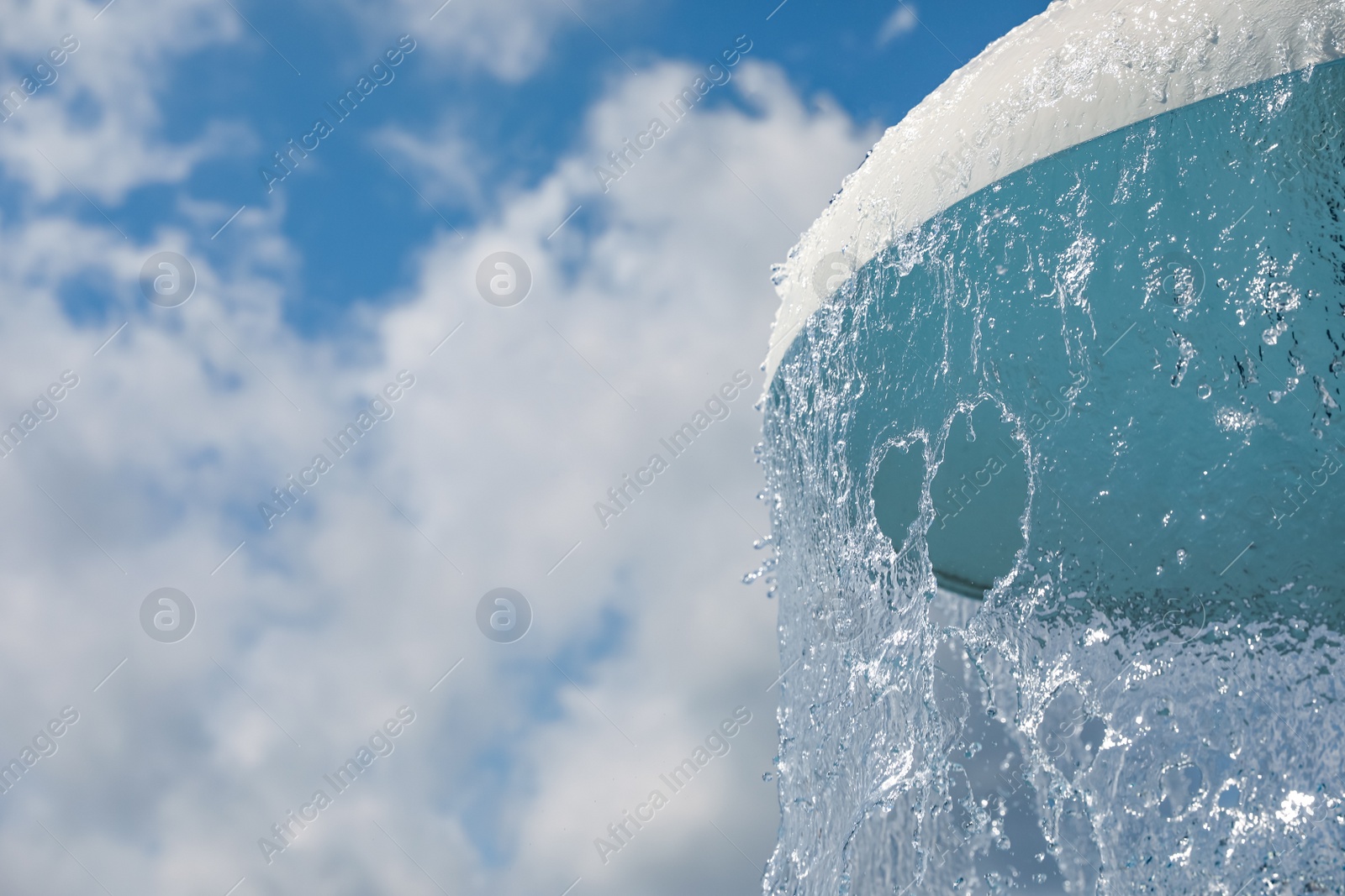 Photo of Shower fountain against blue sky, closeup with space for text. Summer vacation