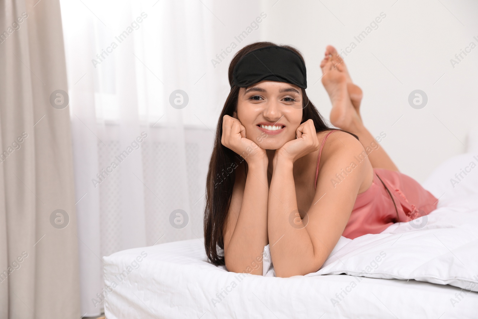 Photo of Beautiful woman wearing sleeping mask at home. Bedtime