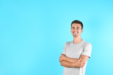 Photo of Portrait of handsome young man smiling on color background. Space for text