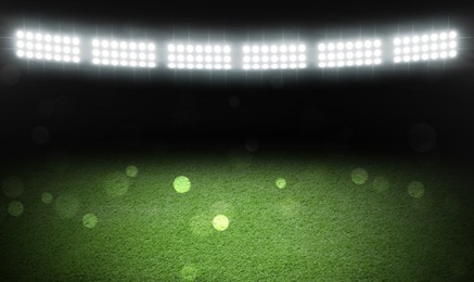 Image of Green sports field under stadium lights, bokeh effect. Banner design