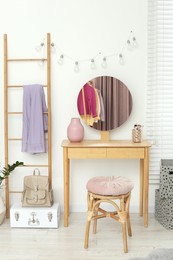 Photo of Stylish teenager's room interior with wooden furniture and mirror