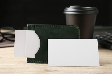 Photo of Leather business card holder with blank cards on wooden table