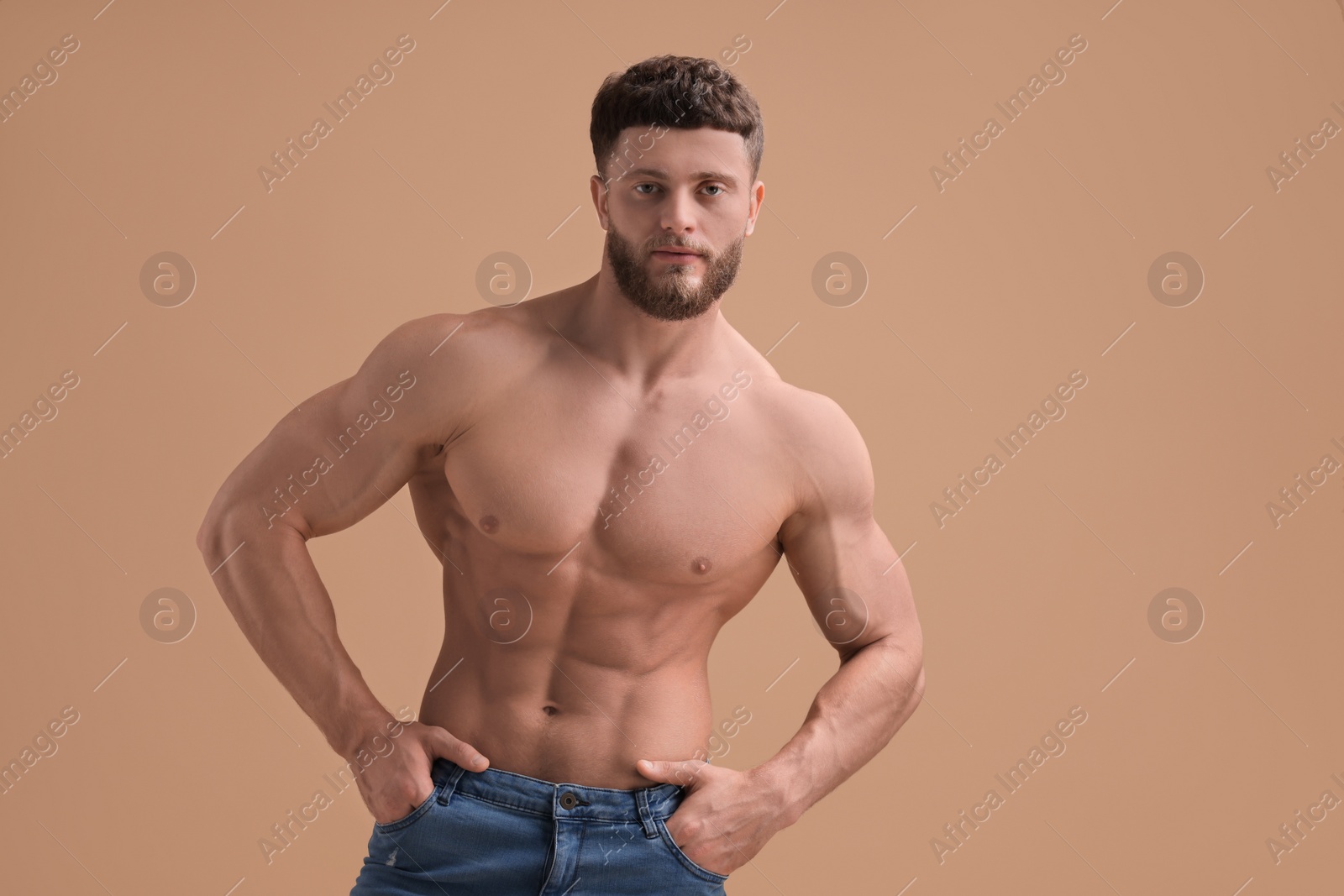 Photo of Handsome muscular man on beige background. Sexy body