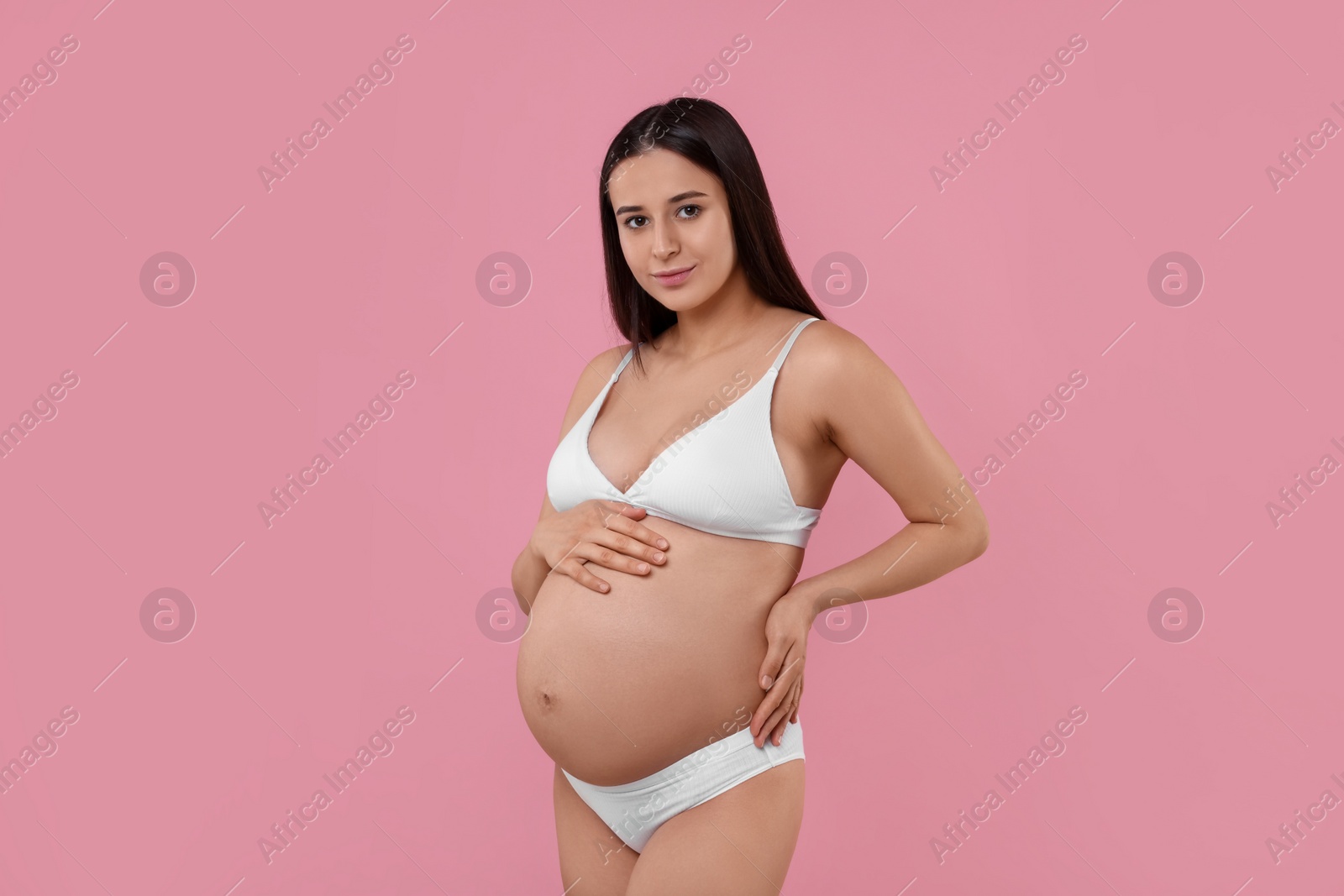 Photo of Beautiful pregnant woman in stylish comfortable underwear on pink background