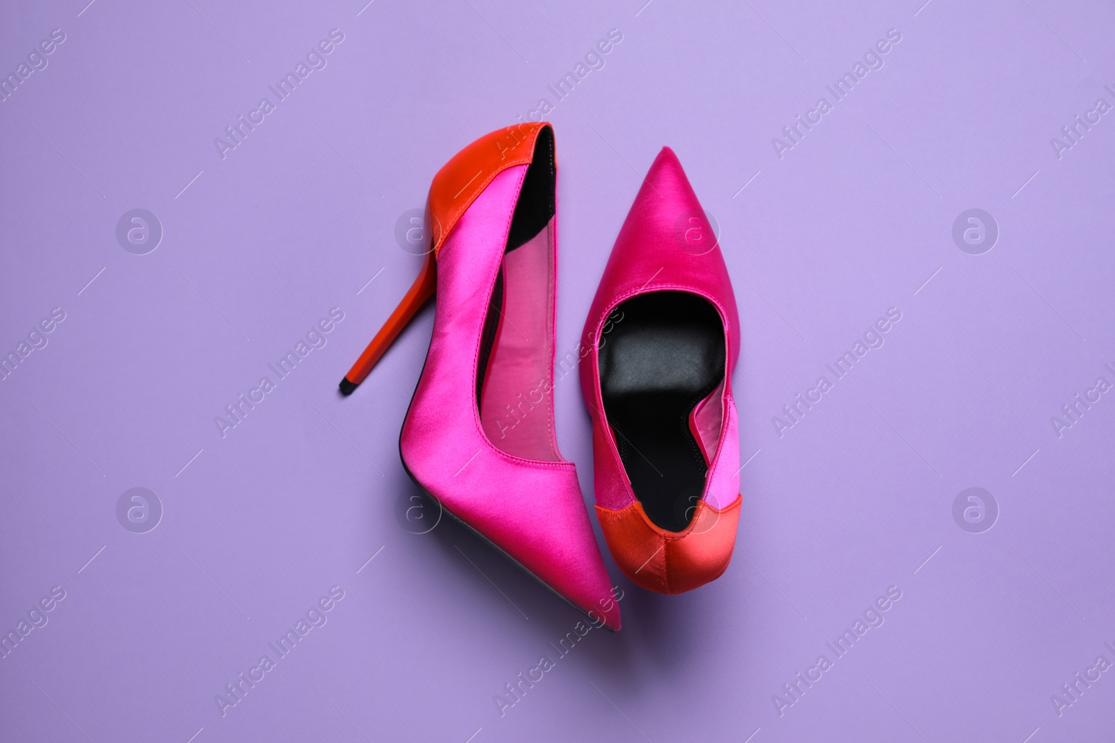 Photo of Pair of beautiful shoes on lilac background, top view