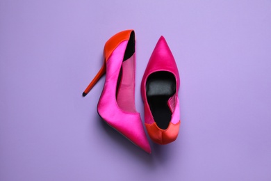 Pair of beautiful shoes on lilac background, top view