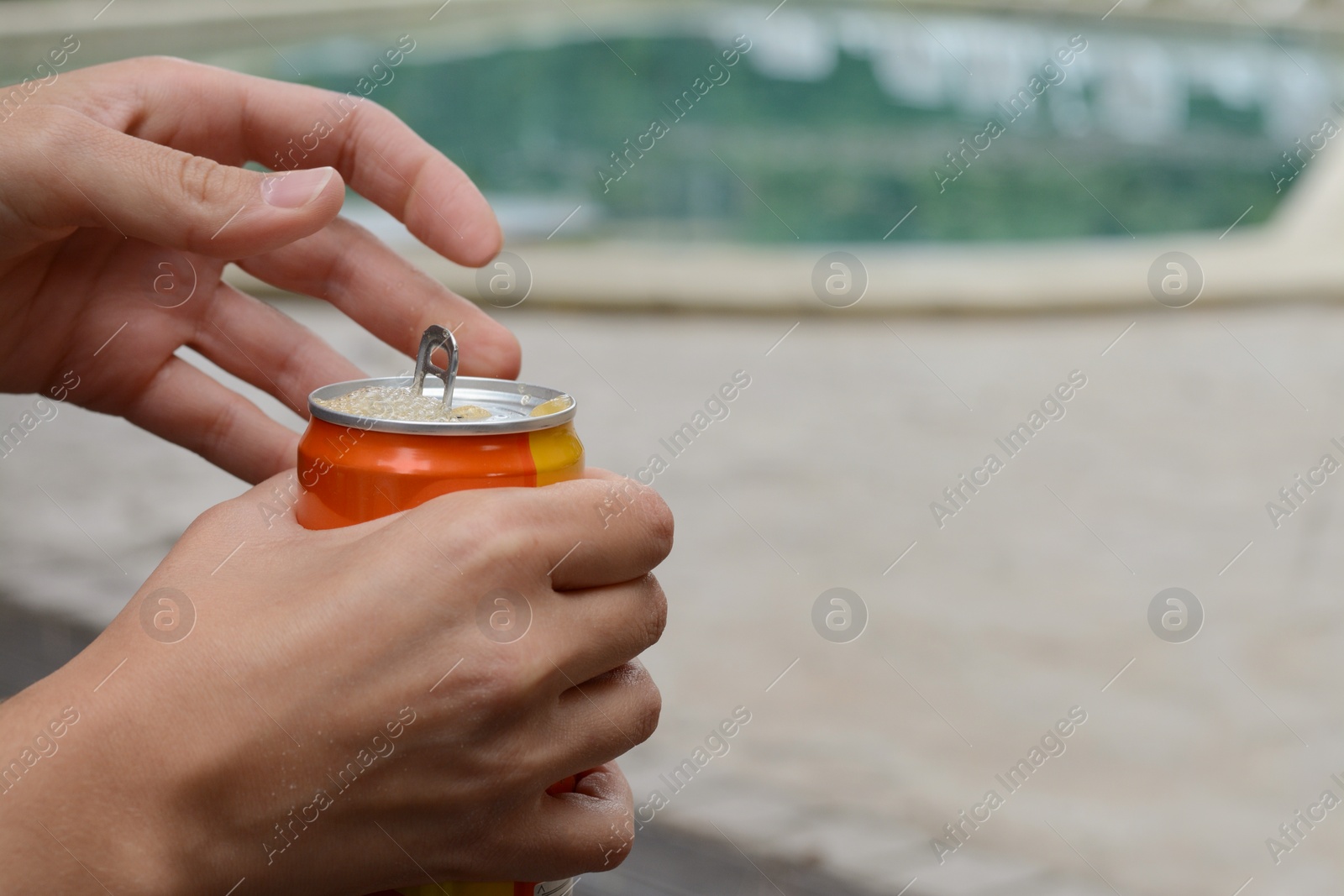 Photo of Woman opening tasty canned beverage outdoors, closeup. Space for text