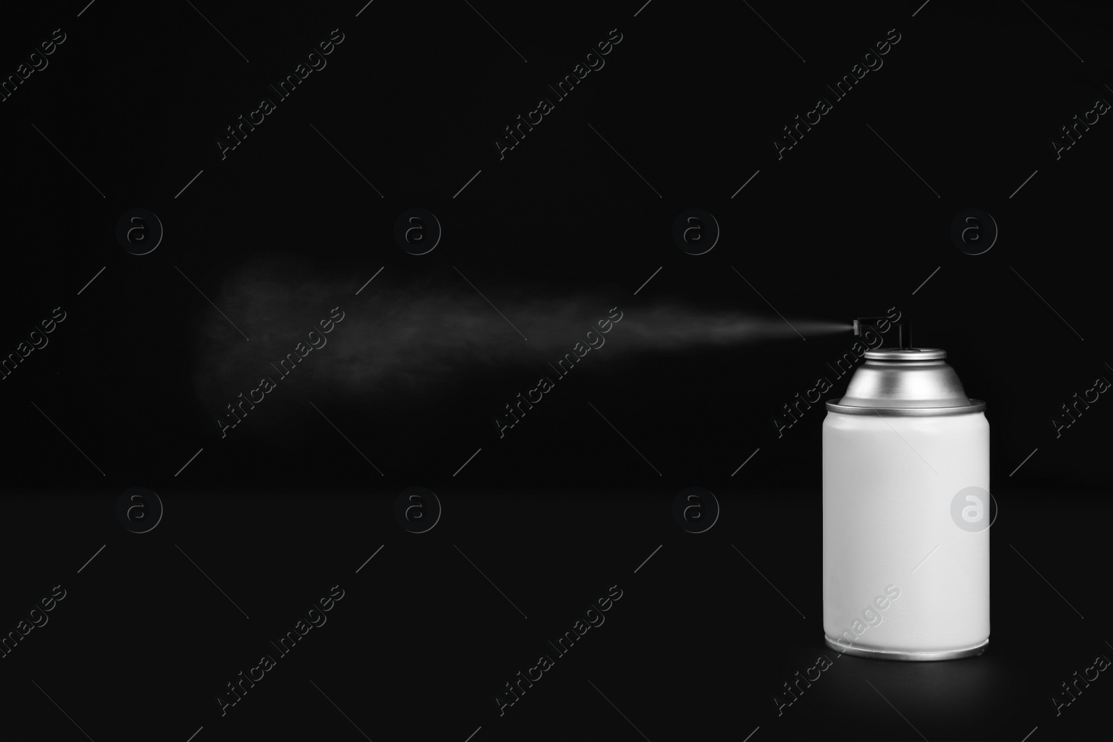 Photo of Woman spraying air freshener on black background, closeup