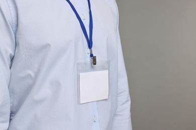 Photo of Man with empty badge on grey background, closeup. Space for text