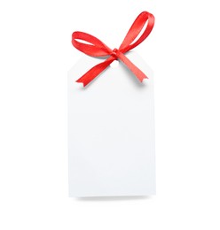 Blank gift tag with red satin ribbon on white background, top view