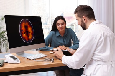 Photo of Young woman having appointment with neurologist in clinic