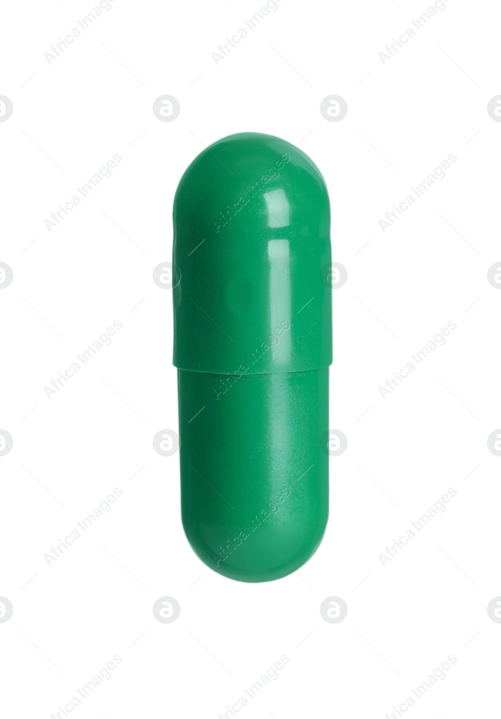 Photo of One green pill on white background. Medicinal treatment