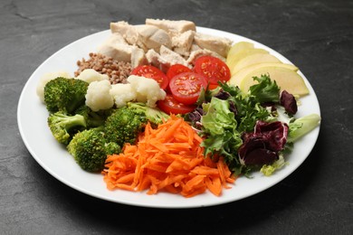 Photo of Balanced diet and healthy foods. Plate with different delicious products on black table, closeup