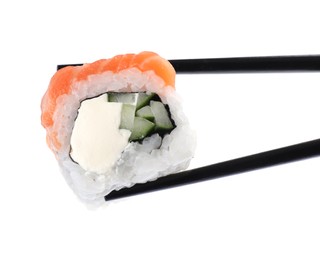 Photo of Chopsticks with tasty sushi roll on white background, closeup