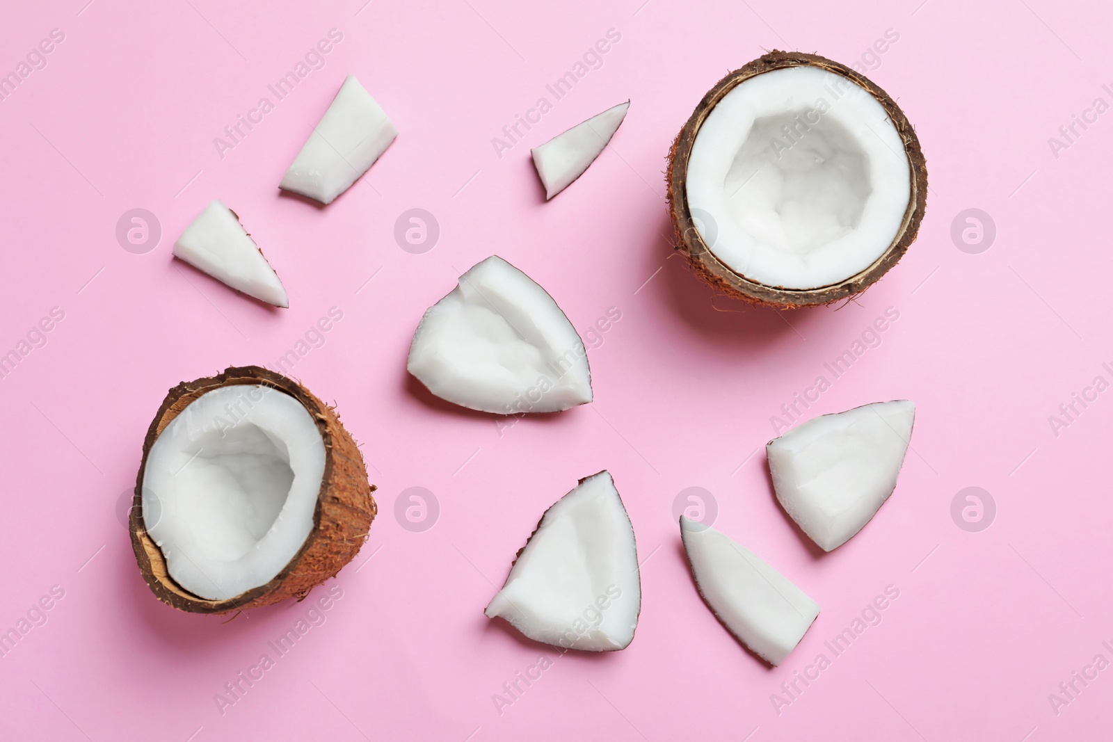 Photo of Ripe coconuts on color background, top view