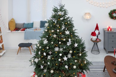 Photo of Beautiful Christmas tree and stylish furniture in cozy room. Interior design