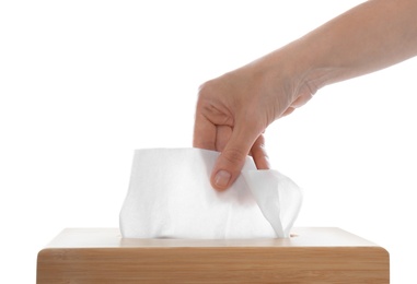 Photo of Woman taking paper tissue from holder on white background, closeup