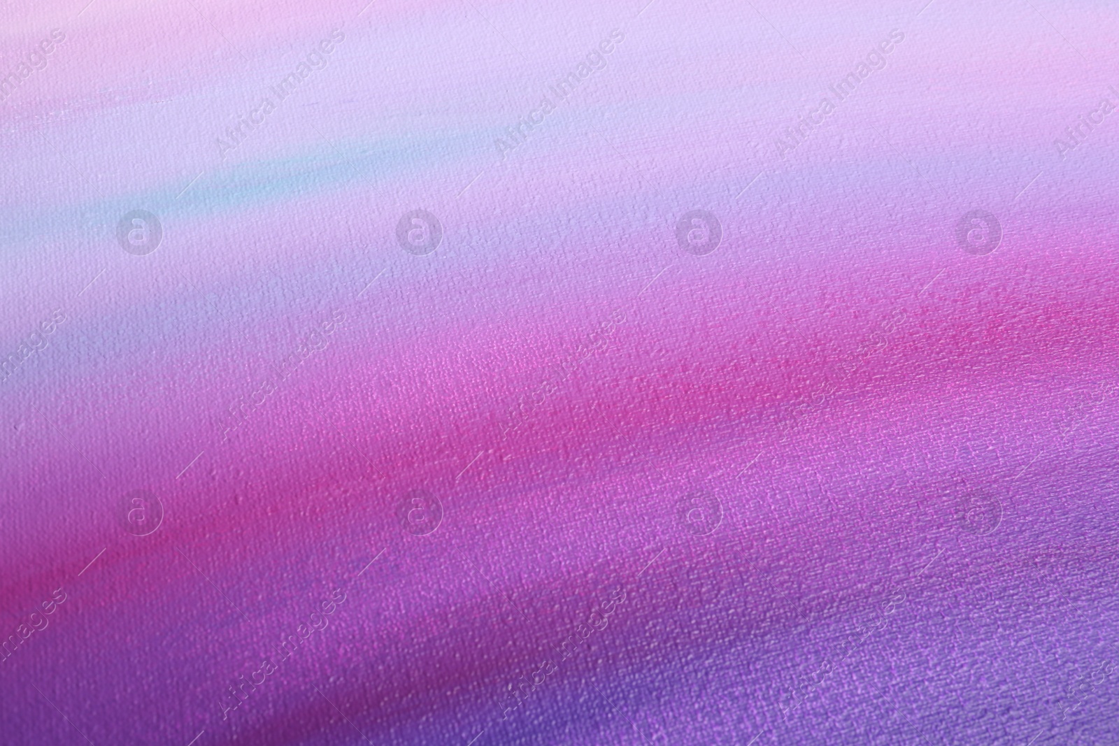 Photo of Canvas with colorful gradient painting, closeup view