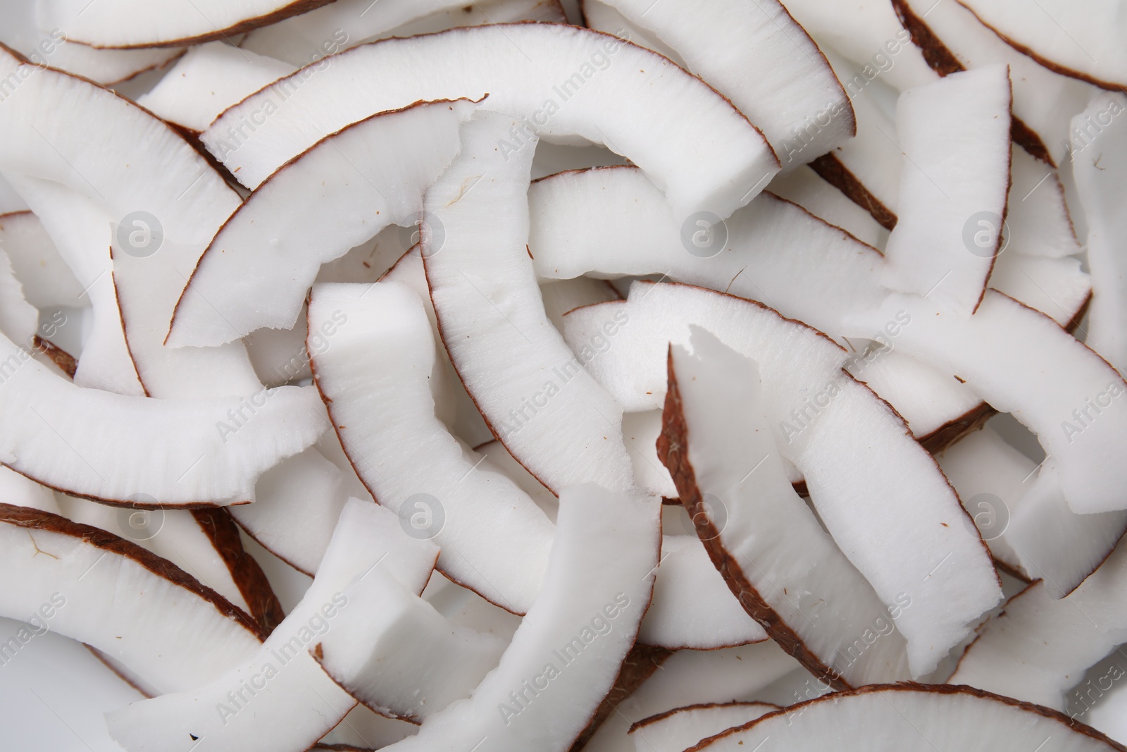 Photo of Fresh coconut pieces as background, top view