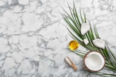 Composition with coconut oil on marble table, top view. Healthy cooking