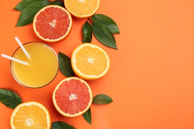 Delicious orange juice and fresh fruits on color background, flat lay. Space for text