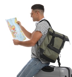 Man with suitcase and backpack reading map on white background. Summer travel