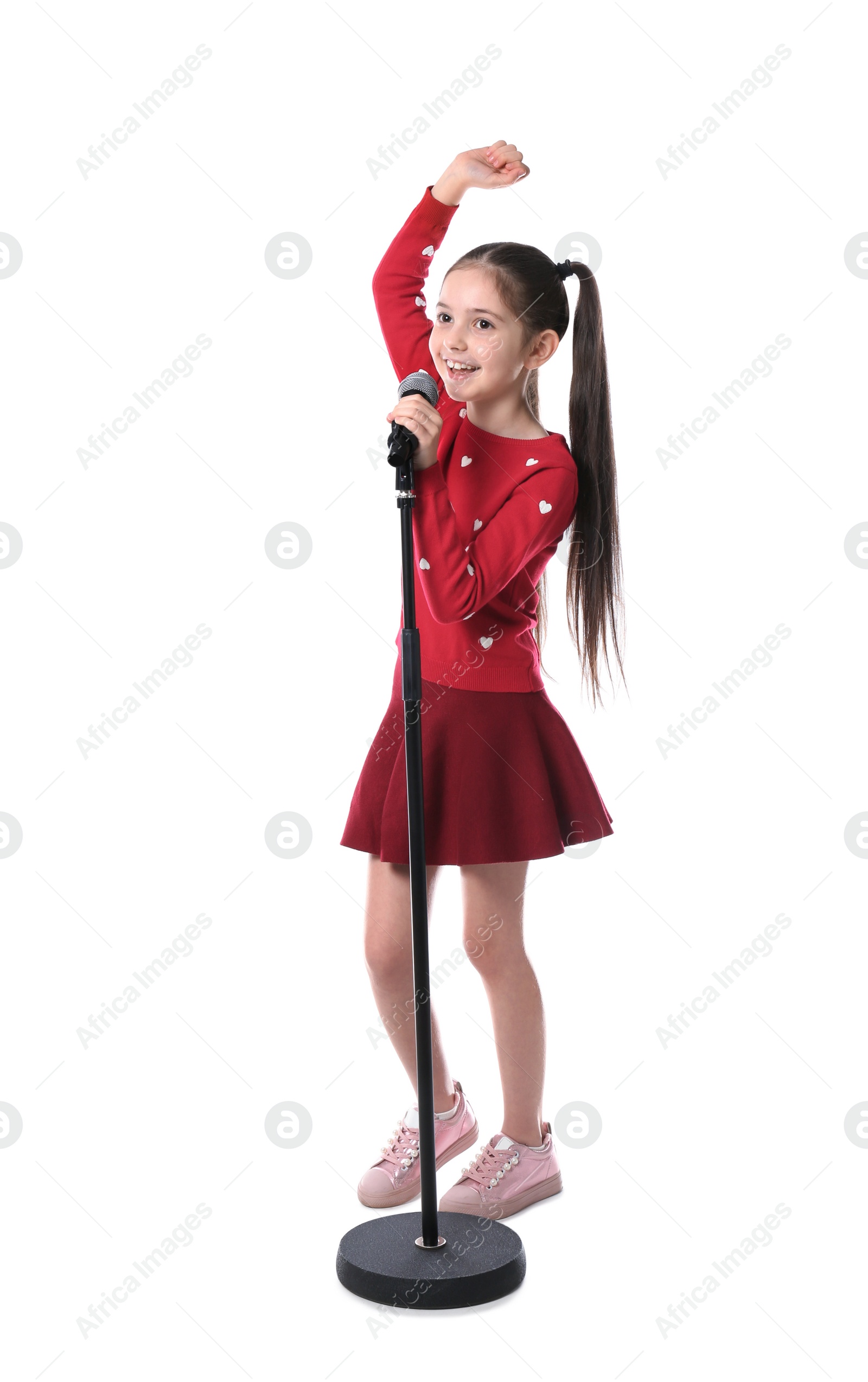 Photo of Little girl singing into microphone on white background