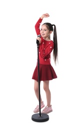 Little girl singing into microphone on white background