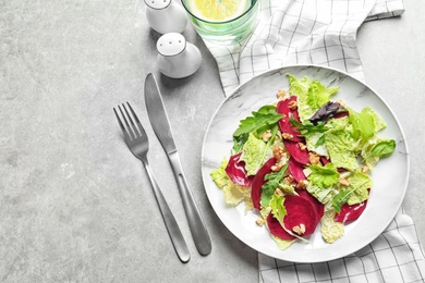 Plate with delicious beet salad on table, top view