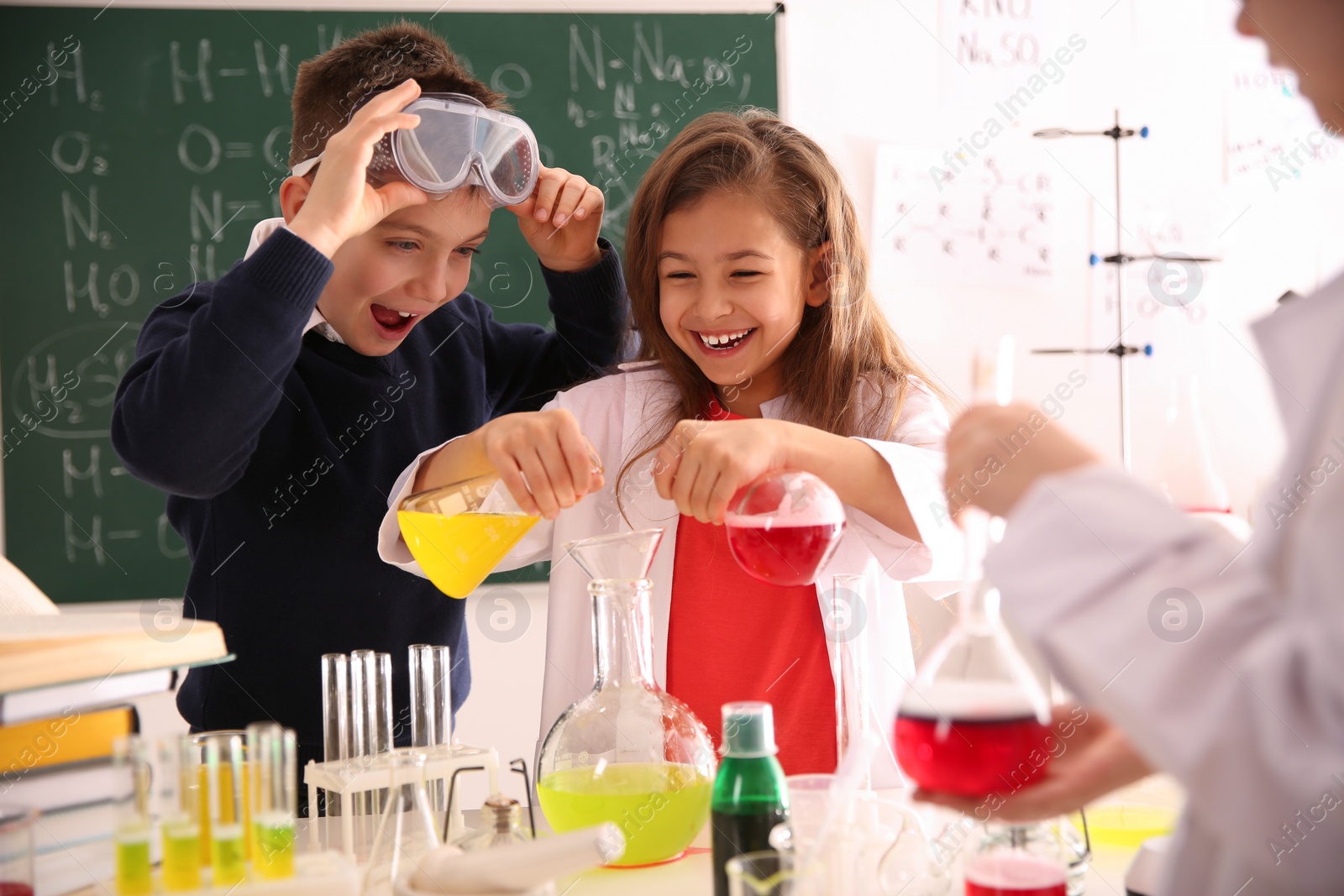 Photo of Smart pupils making experiment in chemistry class