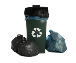 Photo of Dark green recycling bin overfilled with garbage bags on white background