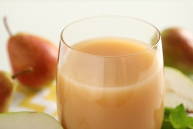 Tasty fresh pear juice in glass, closeup