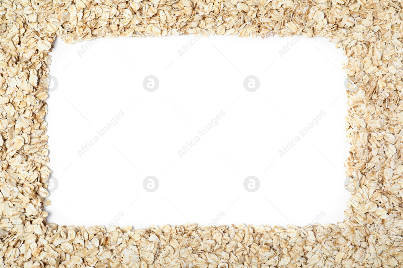 Photo of Frame of raw oatmeal on white background, top view. Space for text