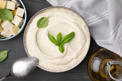 Photo of Delicious tofu sauce and ingredients on grey wooden table, flat lay