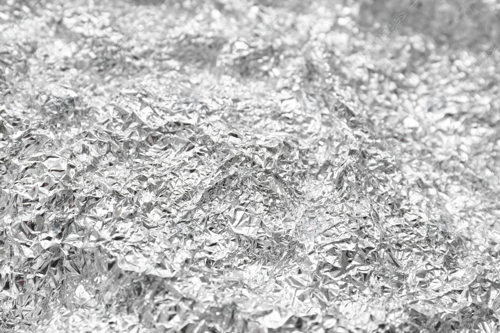 Photo of Crumpled silver foil as background, closeup view