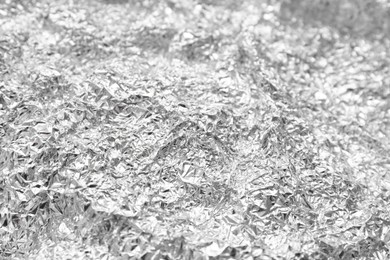 Crumpled silver foil as background, closeup view