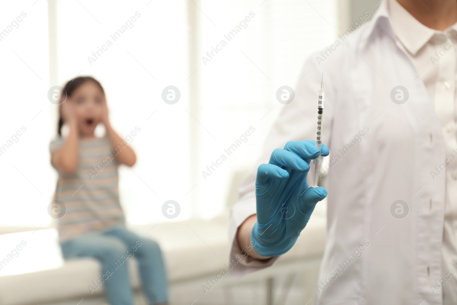 Photo of Doctor with syringe in clinic, closeup. Vaccination day
