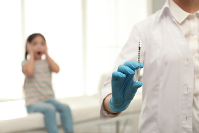 Doctor with syringe in clinic, closeup. Vaccination day