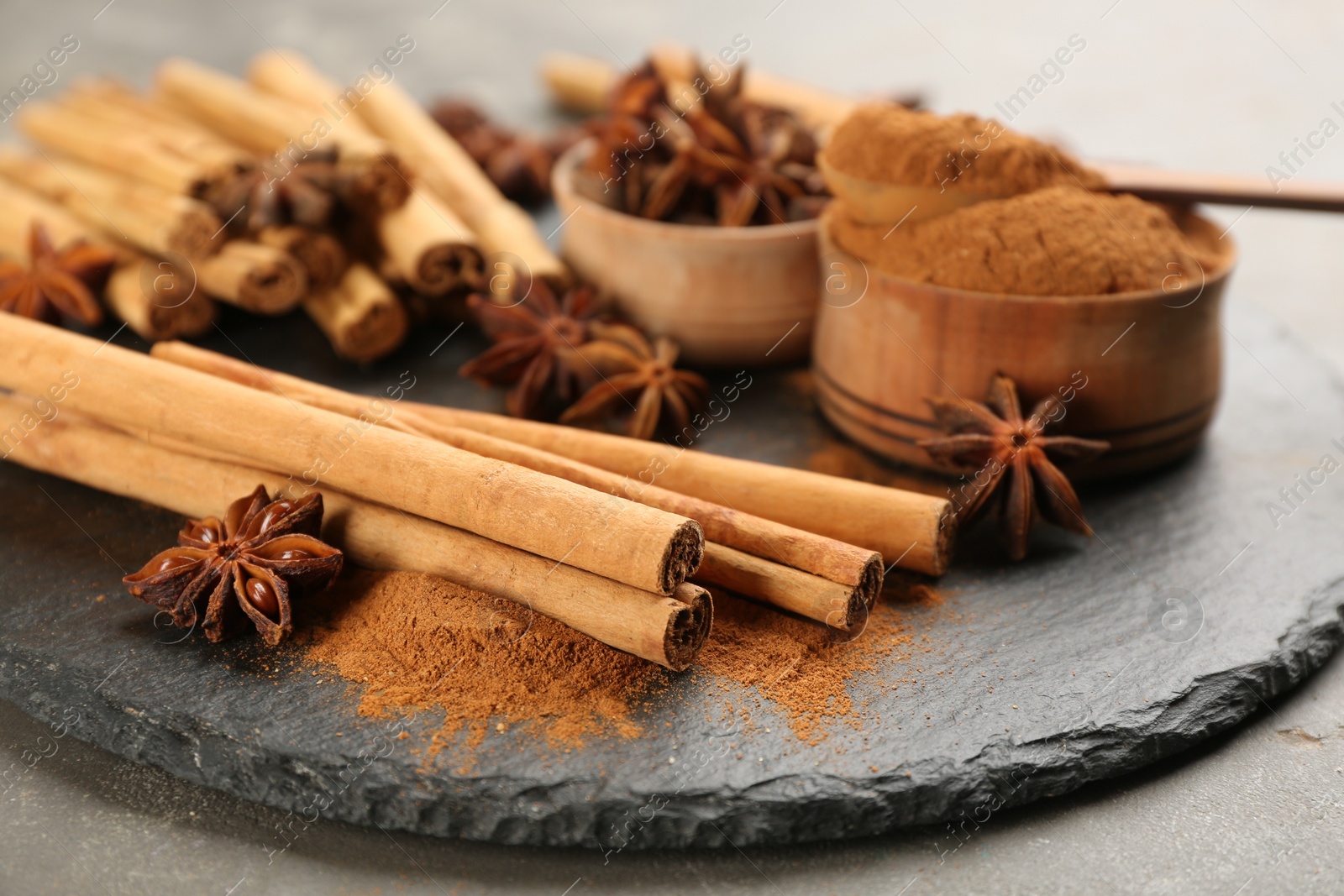 Photo of Aromatic cinnamon and anise on slate plate, closeup