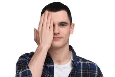 Young man covering his eye on white background