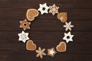 Frame of different delicious Christmas cookies on wooden table, flat lay. Space for text