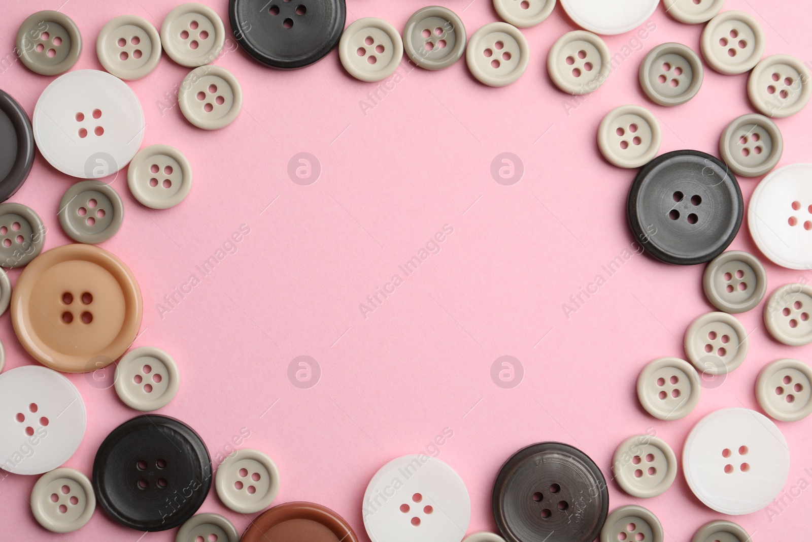 Photo of Frame of sewing buttons on pink background, flat lay. Space for text