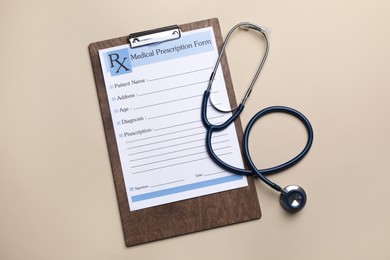 Photo of Clipboard with medical prescription form and stethoscope on beige background, flat lay
