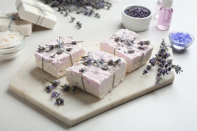 Photo of Hand made soap bars with lavender flowers on cutting board