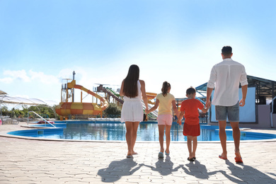 Photo of Family at water park, back view.  Summer vacation