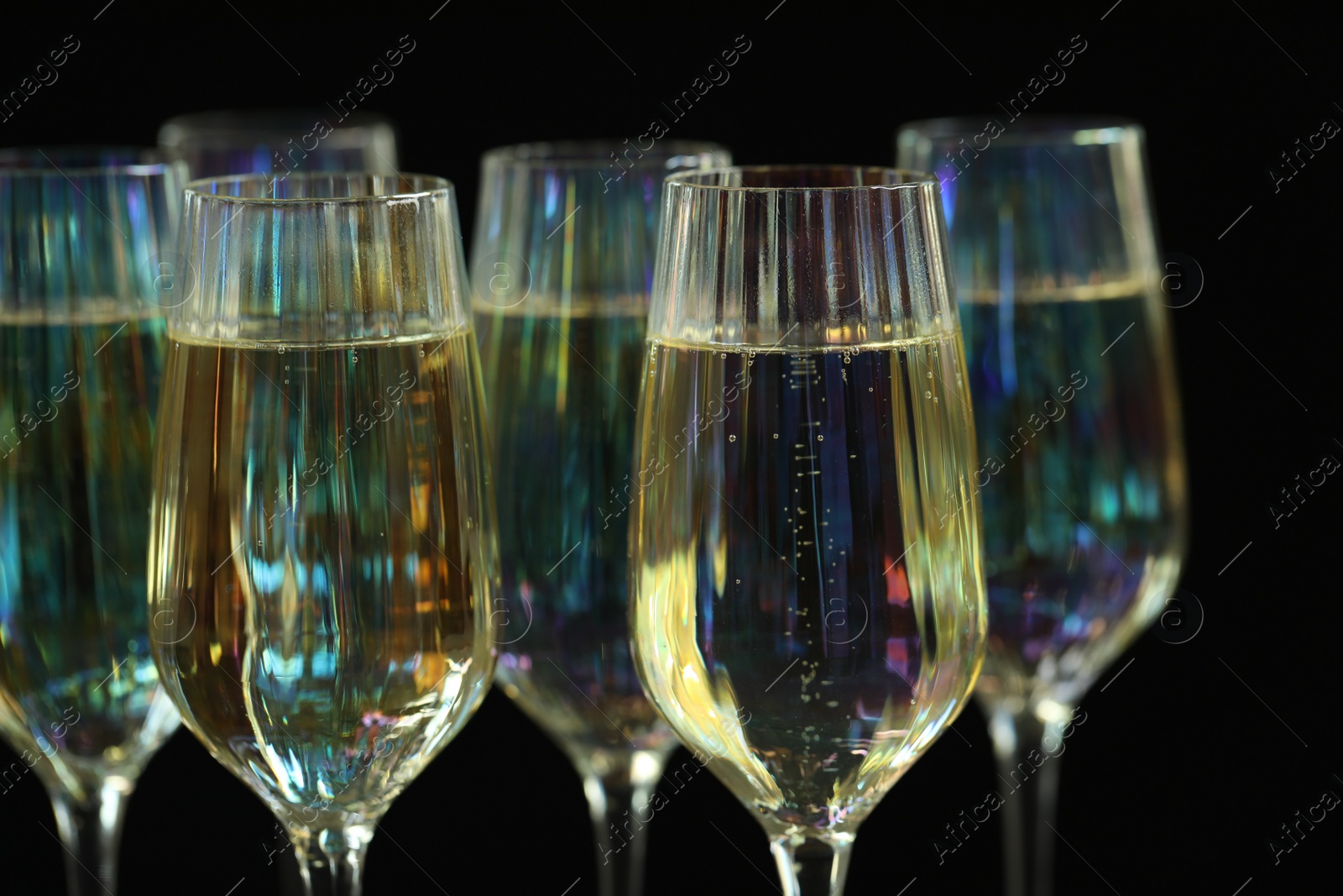 Photo of Glasses of champagne on black background, closeup