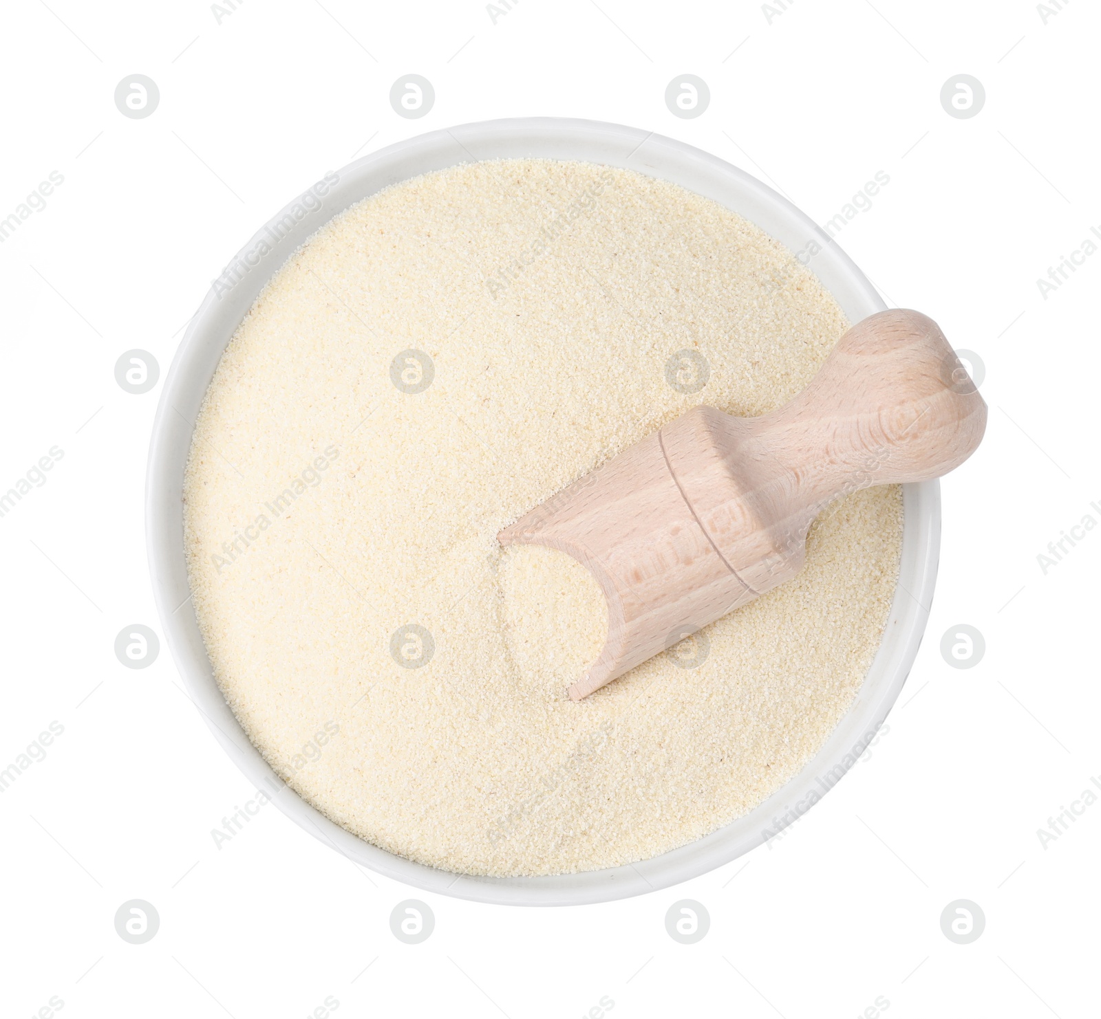 Photo of Bowl of uncooked organic semolina with wooden scoop isolated on white, top view