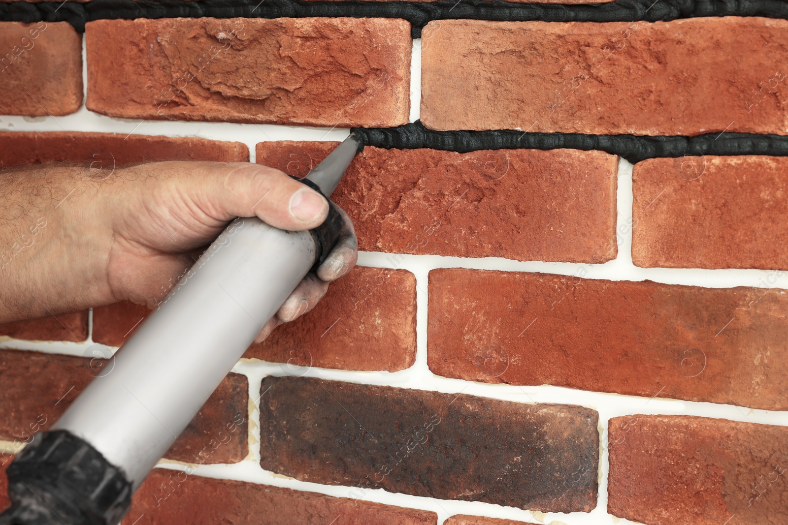 Photo of Professional builder using tiling fugue for grouting, closeup